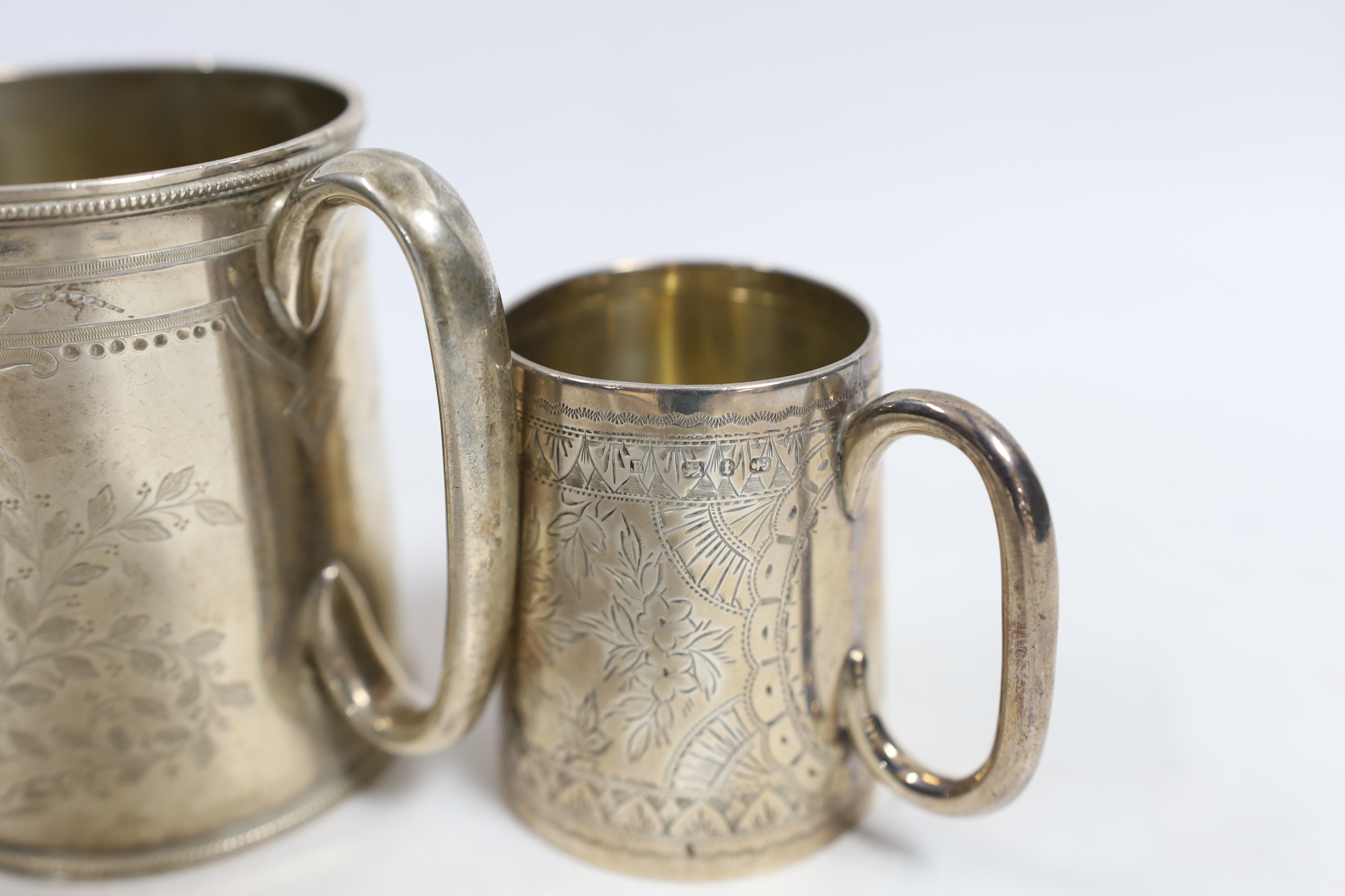 A Victorian engraved silver christening mug, Roberts & Belk, Sheffield, 1873, 87mm, together with another smaller engraved silver mug, Birmingham, 1893.